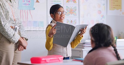Child, reading and classroom with girl speaker, book and education at a school. Students, learning and notebook with development, knowledge and study work with story discussion of youth assessment