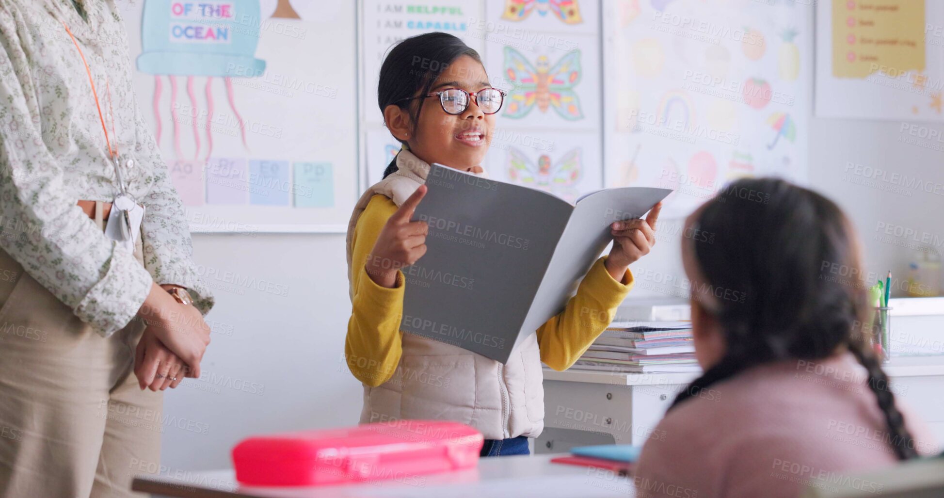 Buy stock photo Child, reading and classroom with girl speaker, book and education at a school. Students, learning and notebook with development, knowledge and study work with story discussion of youth assessment