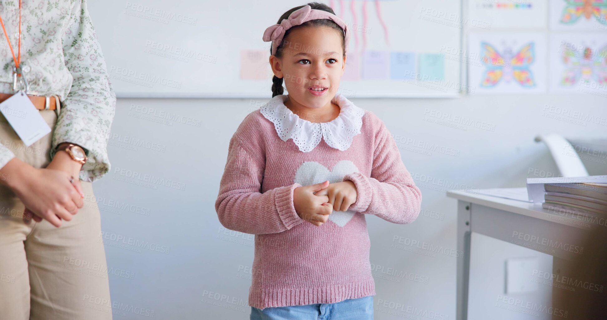 Buy stock photo Girl child, classroom presentation and speech for oral assessment with teacher, development and language. Shy female kid, story and speaking for test, exam and education in class, school or academy