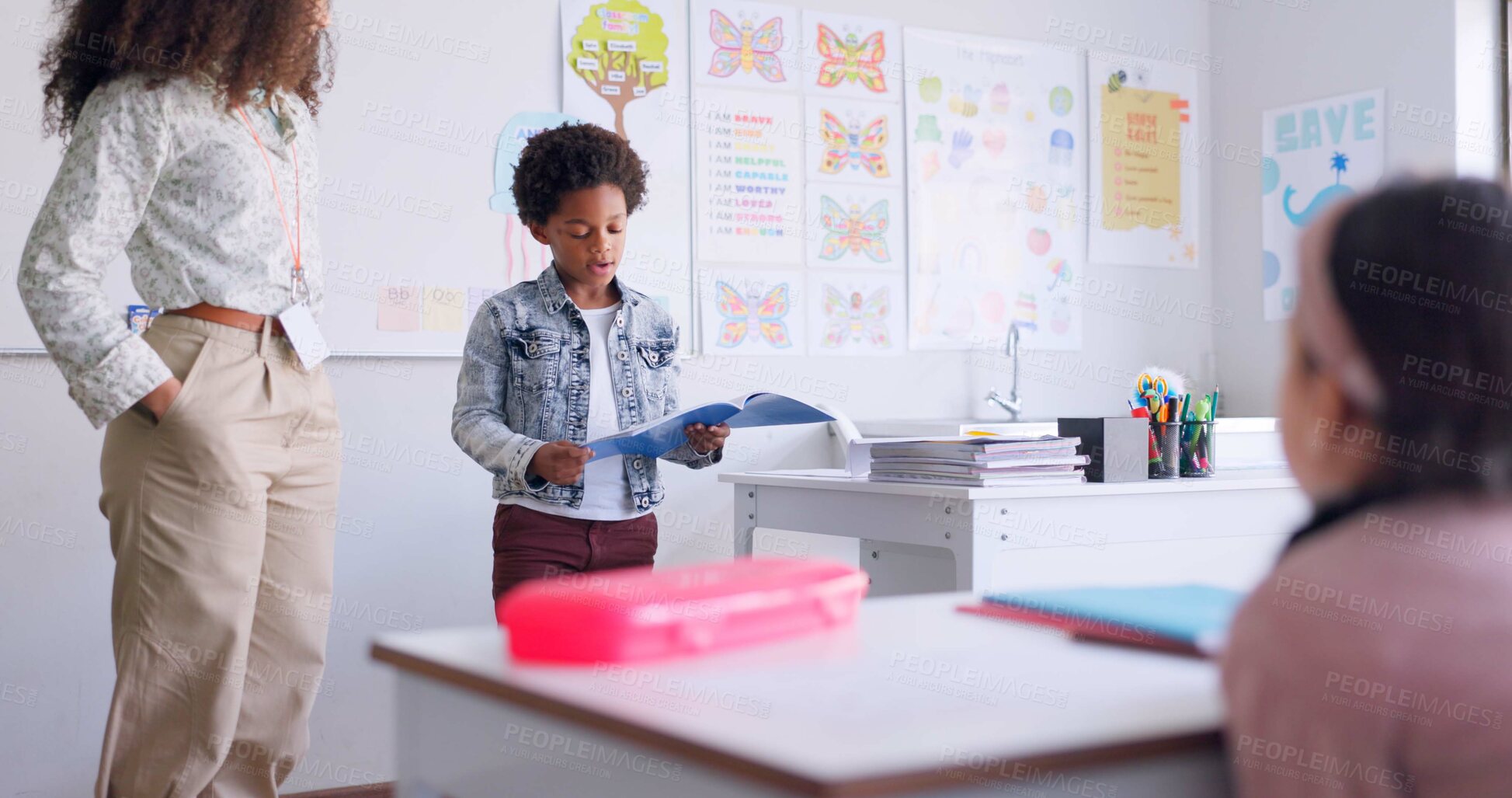 Buy stock photo Child, kid reading and classroom with talking speaker, book and education at a school. Students, learning and notebook with development, knowledge and study with story discussion of youth assessment