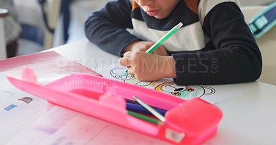 Creative, school and hands of child drawing in a classroom for art lesson for education and development in class. Closeup, kindergarten and kid or student learning artistic homework on a desk