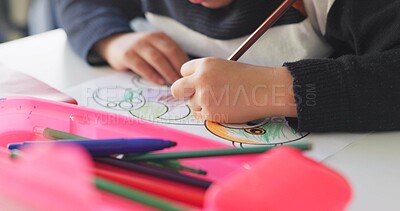 Creativity, school and hands of child drawing in a classroom for art lesson for education and development in class. Closeup, kindergarten and kid or student learning artistic homework on a desk