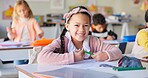 Smile, education and study with girl in classroom for learning, knowledge and writing. Scholarship, happy and future with portrait of young student at school for academy, exam test and project