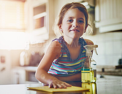 Buy stock photo Portrait of a little girl cleaning a kitchen surface at home