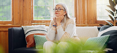 Thinking, reflection and senior woman on sofa in the living room with memory or dreaming face. Relax, idea and elderly female person in retirement with alzheimers disease in the lounge of modern home