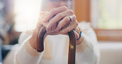 Walking stick, hands and senior woman with a disability in home, apartment or retirement with support for injury. Elderly, closeup or person with wood cane to help balance or mobility with arthritis