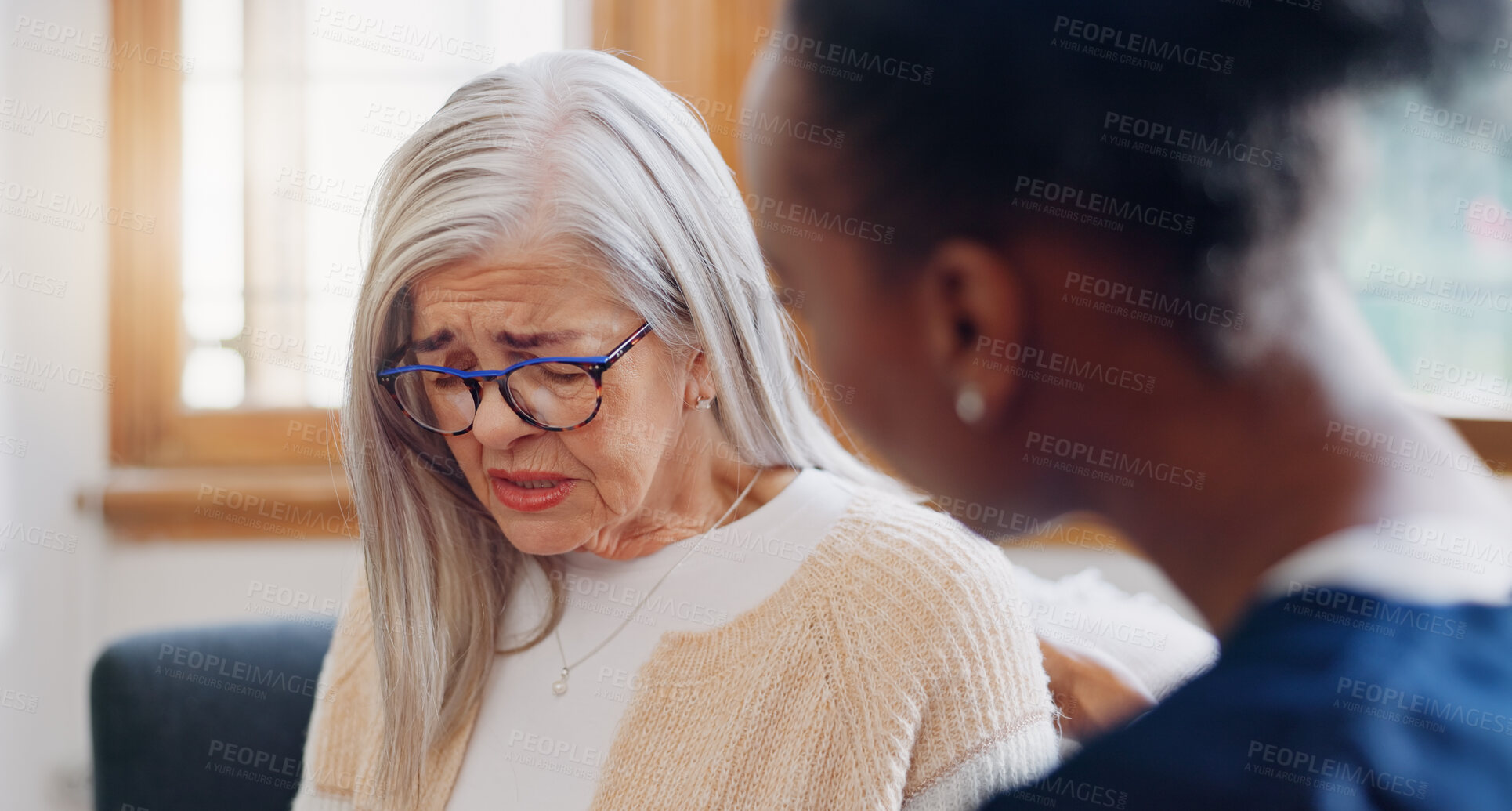 Buy stock photo Senior, sad woman speaking or nurse with support or results in consultation for bad news or cancer. Stress, depression or caregiver with a crying mature patient for empathy, sympathy or help in home