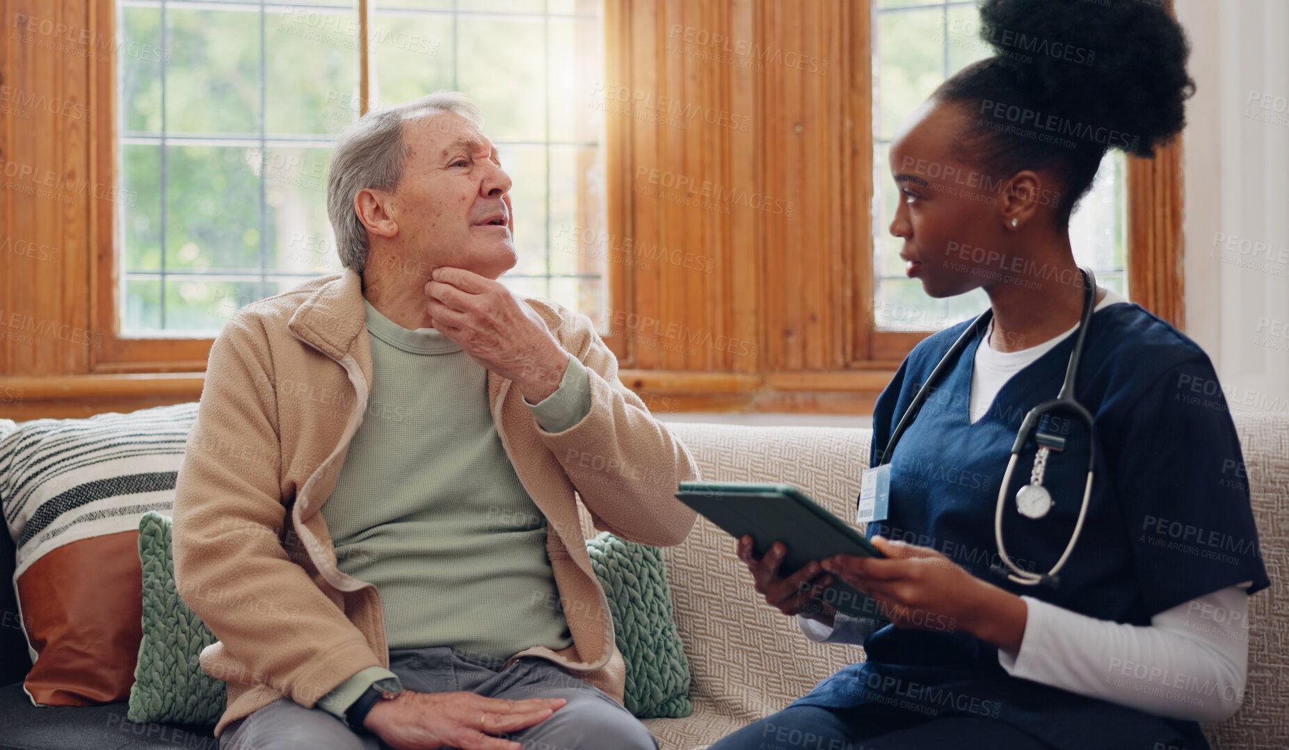 Buy stock photo Healthcare, tablet and a senior man with a caregiver during a home visit for medical checkup in retirement. Technology, medicine and appointment with a nurse talking to an elderly patient on the sofa