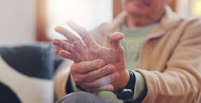 Closeup, hands and senior man with wrist pain, injury and inflammation with bruise, home and broken. Zoom, pensioner and elderly guy on a couch, fingers with ache and arthritis with sprain and strain