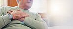 Hands, heart attack or condition with a senior man in pain closeup in the living room of his retirement home. Healthcare, chest or cardiac arrest with an elderly person breathing for lung oxygen