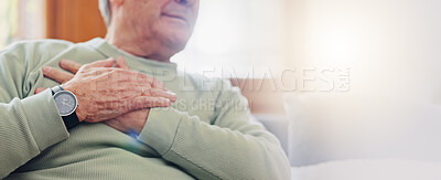Hands, heart attack or condition with a senior man in pain closeup in the living room of his retirement home. Healthcare, chest or cardiac arrest with an elderly person breathing for lung oxygen
