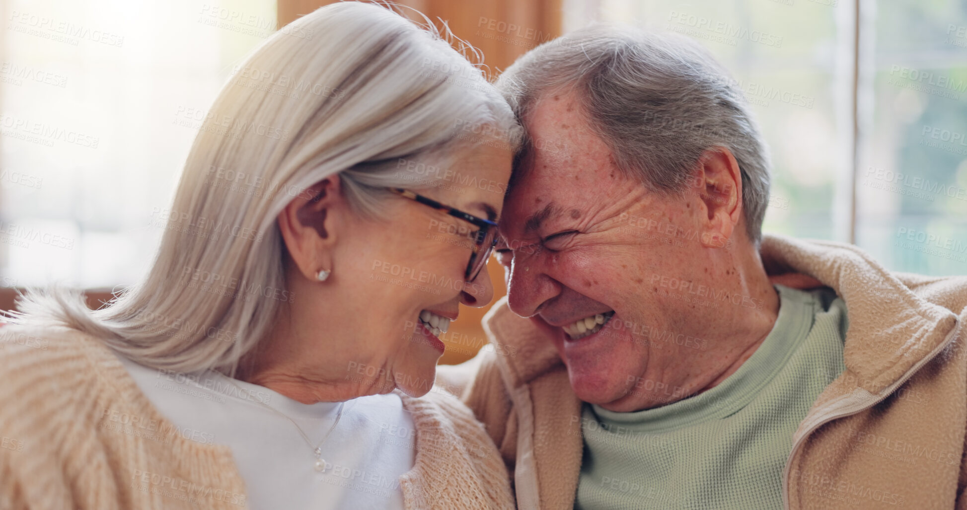 Buy stock photo Senior couple, happy and smiling with laugh and talking with embrace, couch and retired. Retirement, old age home and elderly in living room, couch and bonding together for quality time, hug or care