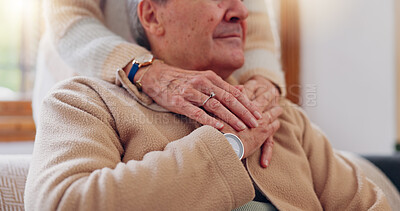 Hands, empathy and a senior couple closeup in their home for love, support or trust during retirement. Hope, healing and sympathy with elderly people on a sofa in the living room of their home
