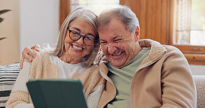 Tablet, social media and a senior couple laughing in the living room of their home together during retirement. Technology, love and relax with funny elderly people looking at a meme on the sofa