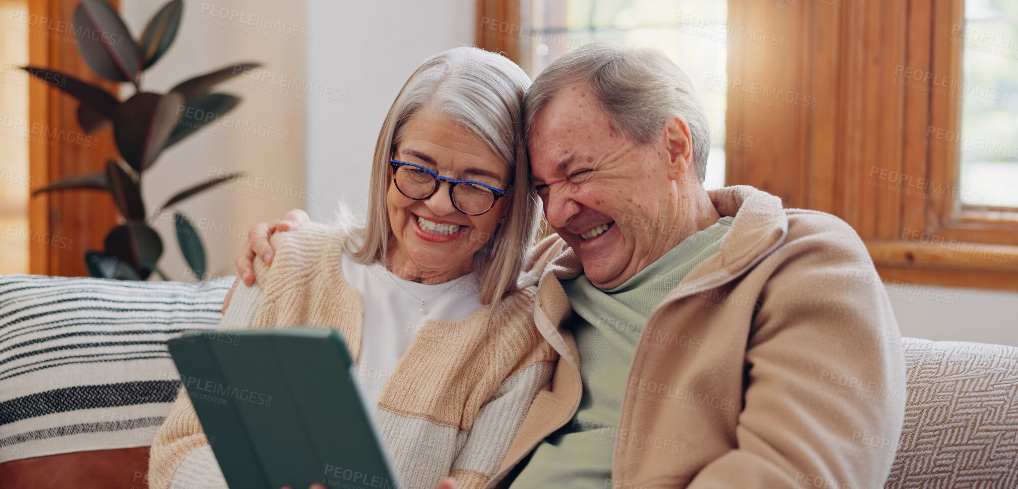 Buy stock photo Tablet, laugh and senior couple on a sofa watching a funny, comic or comedy video on social media. Happy, smile and elderly people in retirement scroll on mobile app or internet on digital technology