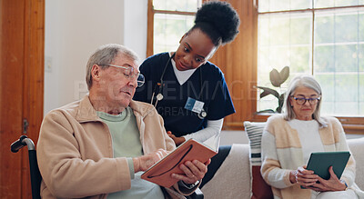 Senior man, reading and nurse talking in home with book, discussion or support from nursing staff. Retirement, elderly care or person relax in conversation with caregiver in living room with notebook