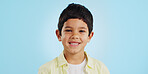 Face, boy child and smile in studio for wellness and confidence on a blue background with positive mindset. Portrait, kid and happiness with casual fashion, joyful and relaxed expression on mockup