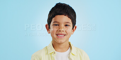 Buy stock photo Face, boy child and smile in studio for wellness and confidence on a blue background with positive mindset. Portrait, kid and happiness with casual fashion, joyful and relaxed expression on mockup