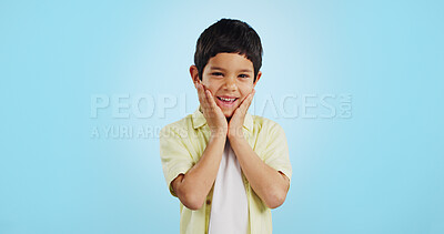 Buy stock photo Excited, kid and hands on face for surprise in studio isolated on a blue background mockup space. Portrait, wow and happy child shocked at good news, information announcement and facial expression.