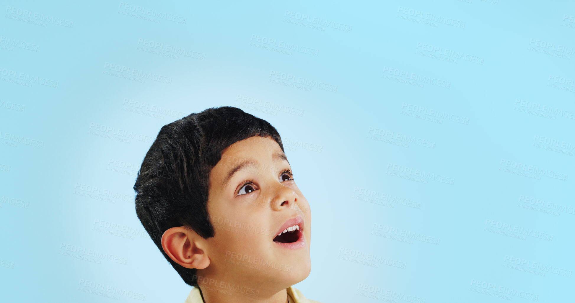 Buy stock photo Surprise, boy and child with decision, opportunity and fantasy on a blue studio background. Person, mockup space and happy kid looking up, future and announcement with shock, expression and emoji