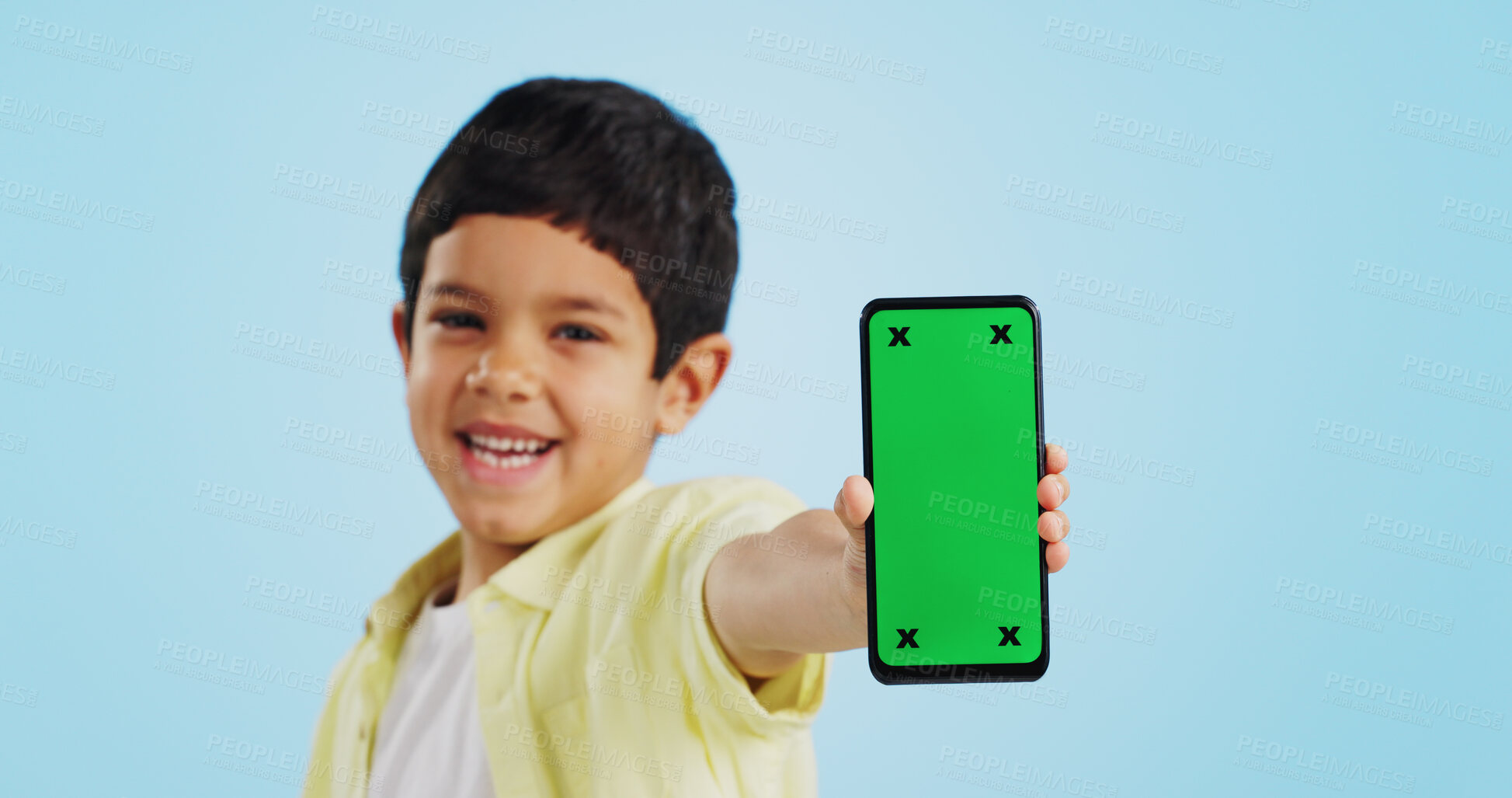 Buy stock photo Kid, face or phone green screen in studio on social media for ecommerce, tech or download app logo. Blue background, space or happy child with notification for online marketing, mockup or advertising