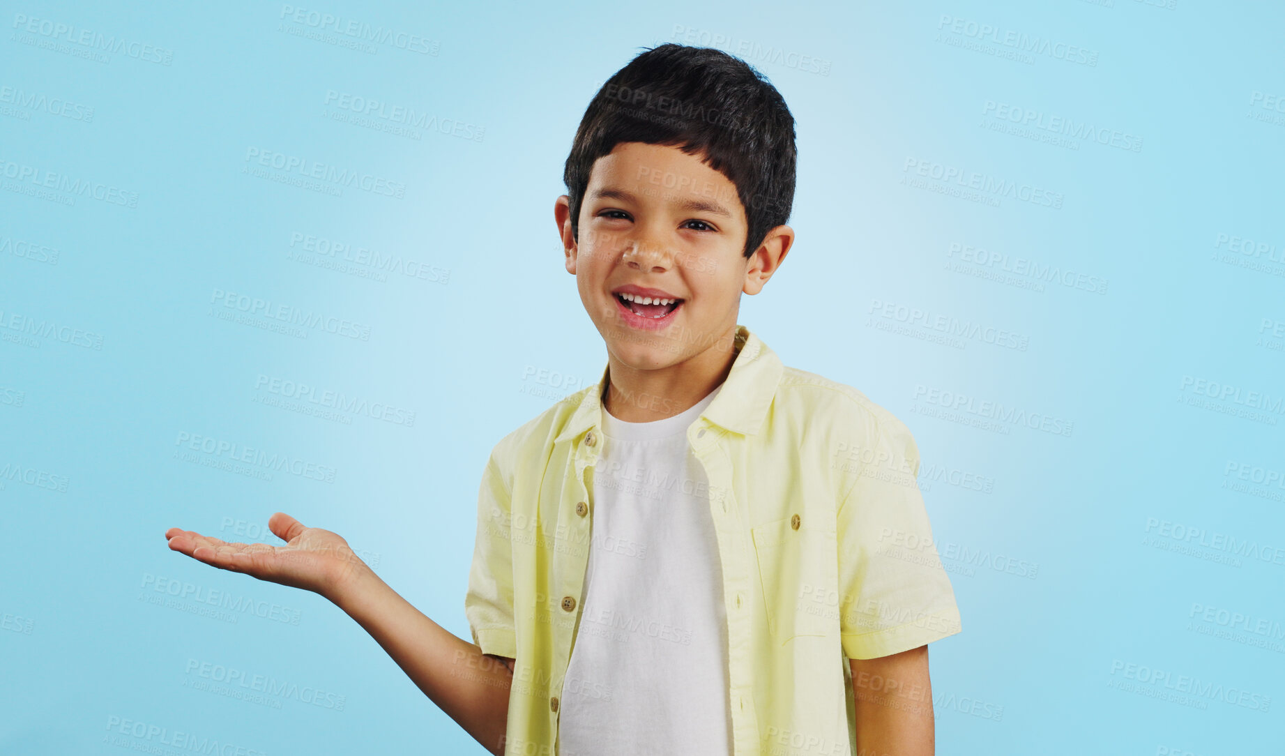 Buy stock photo Kid, smile and happy for presentation in studio on blue background with mockup for product placement. Youth, boy and excited for opportunity, offer or deal on app, social media or digital marketing
