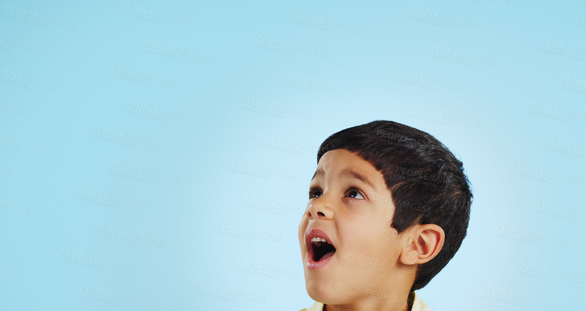 Buy stock photo Surprise, boy and child with decision, opportunity and fantasy on a blue studio background. Person, mockup space and happy kid looking up, future and announcement with shock, expression and emoji