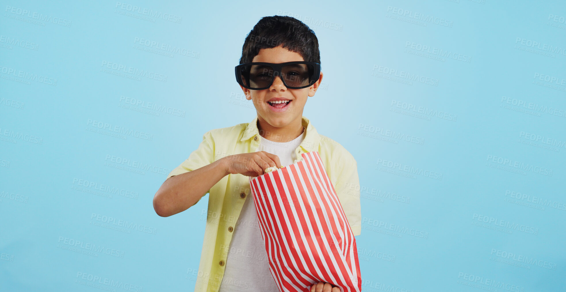 Buy stock photo Popcorn, 3d or child in studio for a movie, watching tv or VR film on blue background with snack. Future technology, virtual reality experience or kid eating food for 3d cinema or metaverse show