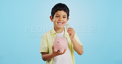 Piggy bank, cash and child face with money, savings and cash planning in a studio, Happy, portrait and young boy with allowance and safe for bills, wealth and budget with blue background and smile