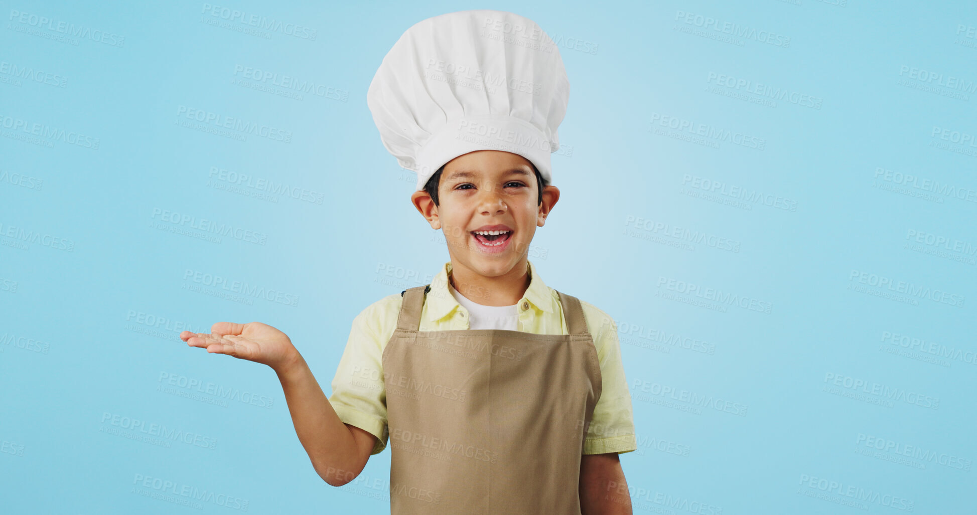 Buy stock photo Child, happy face and chef hand to show promotion, advertising or deal in studio. Dress up, profession and young boy happy from future career of cooking and open palm for sale with blue background