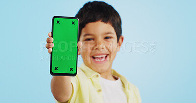 Happy child, face or phone green screen in studio on social media for ecommerce, tech or download app logo. Blue background, space or kid with notification for online marketing, mockup or advertising