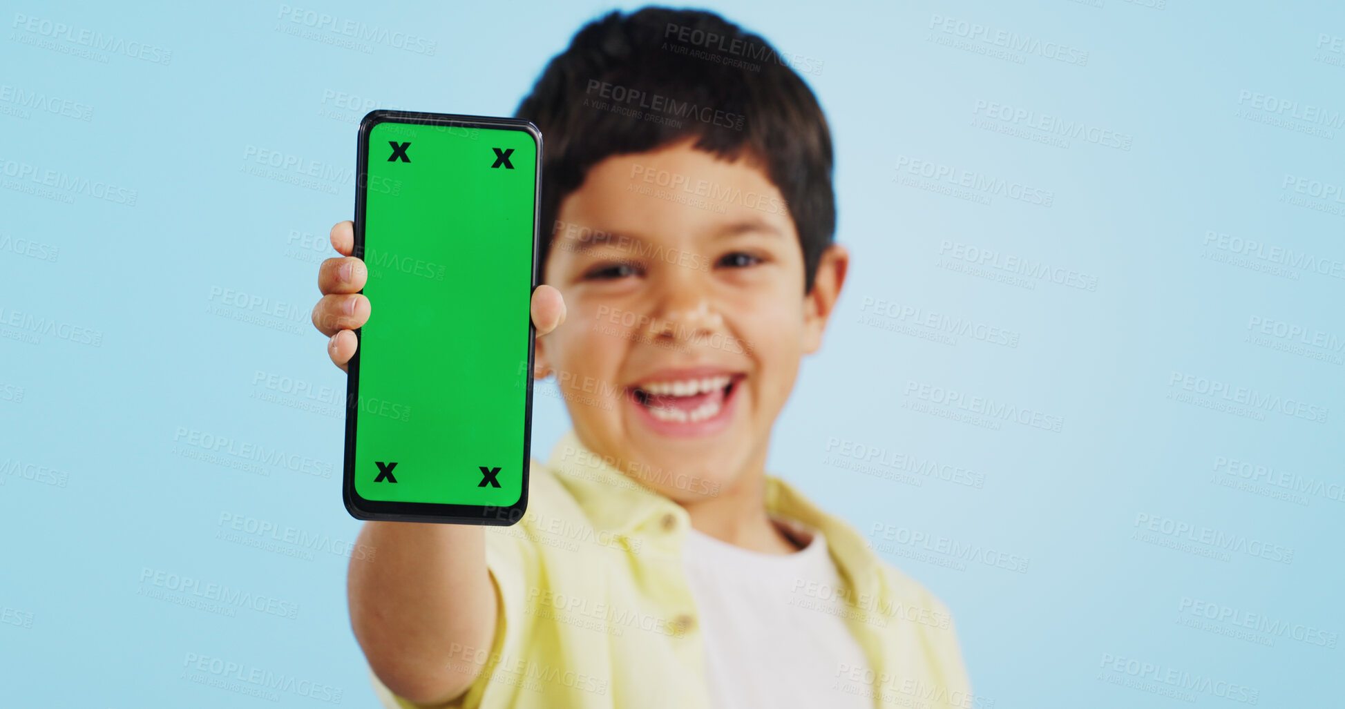 Buy stock photo Happy child, face or phone green screen in studio on social media for ecommerce, tech or download app logo. Blue background, space or kid with notification for online marketing, mockup or advertising