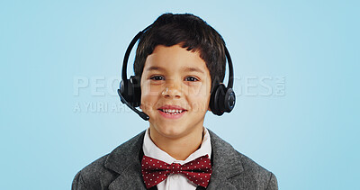 Face, studio or child consultant in call center talking or networking for telecom on blue background. Young, contact or friendly kid sales agent in communication or conversation at customer service
