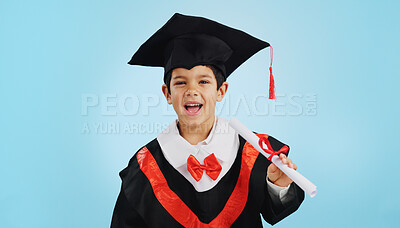 Graduate, child and celebration with portrait and happiness in studio on blue background for education. Development, kid and success with excited expression, diploma or certificate for achievement