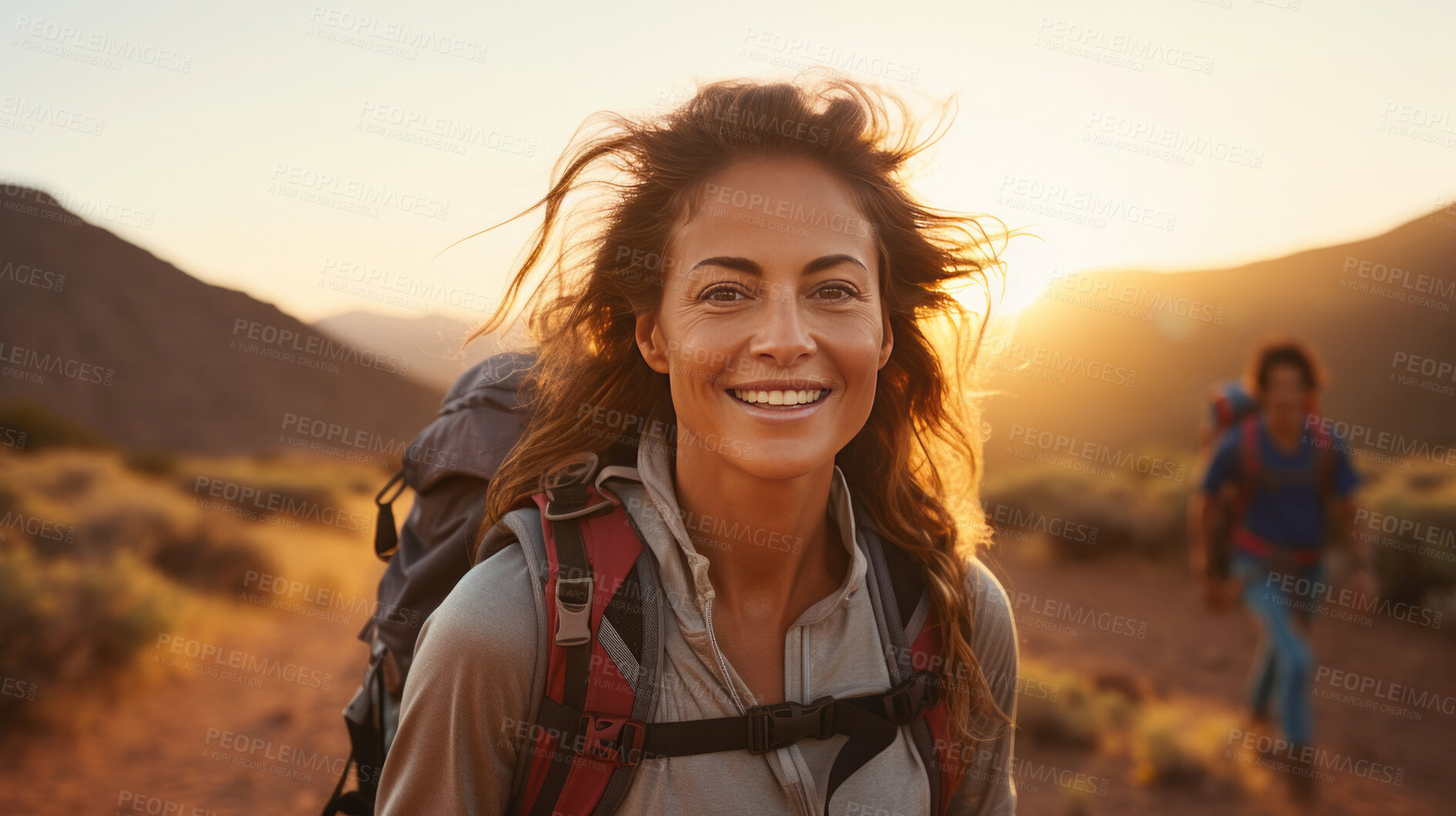 Buy stock photo Portrait of woman smiling at camera during hike. Sunset or sunrise.