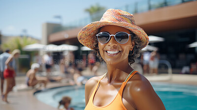 Happy senior woman posing at poolside at holiday resort. Vacation concept.