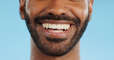 Smile, closeup and black man with teeth in studio, blue background and mockup space with happiness or advertising. Portrait, closeup and marketing for skincare, wellness or healthy dermatology care