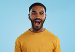 Wow and excited black man in studio isolated on a blue background mockup space. Portrait, surprise and happy person in shock for good news, information and winner of bonus promotion