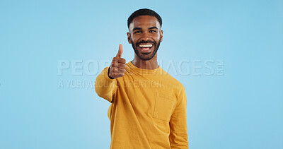Buy stock photo Face, smile and man with thumbs up in studio for support, motivation or vote on blue background. Happy, portrait and excited male model with hand emoji for winning, thank you or success gesture