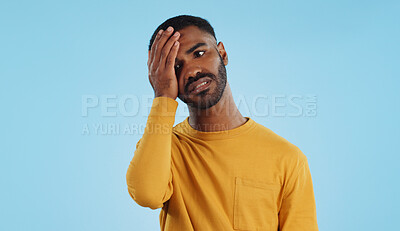 Stress, fail and man in studio with facepalm emoji for stupid mistake or regret on blue background. Anxiety, oops and male model with disaster, crisis or fake news shame, frustrated and unhappy