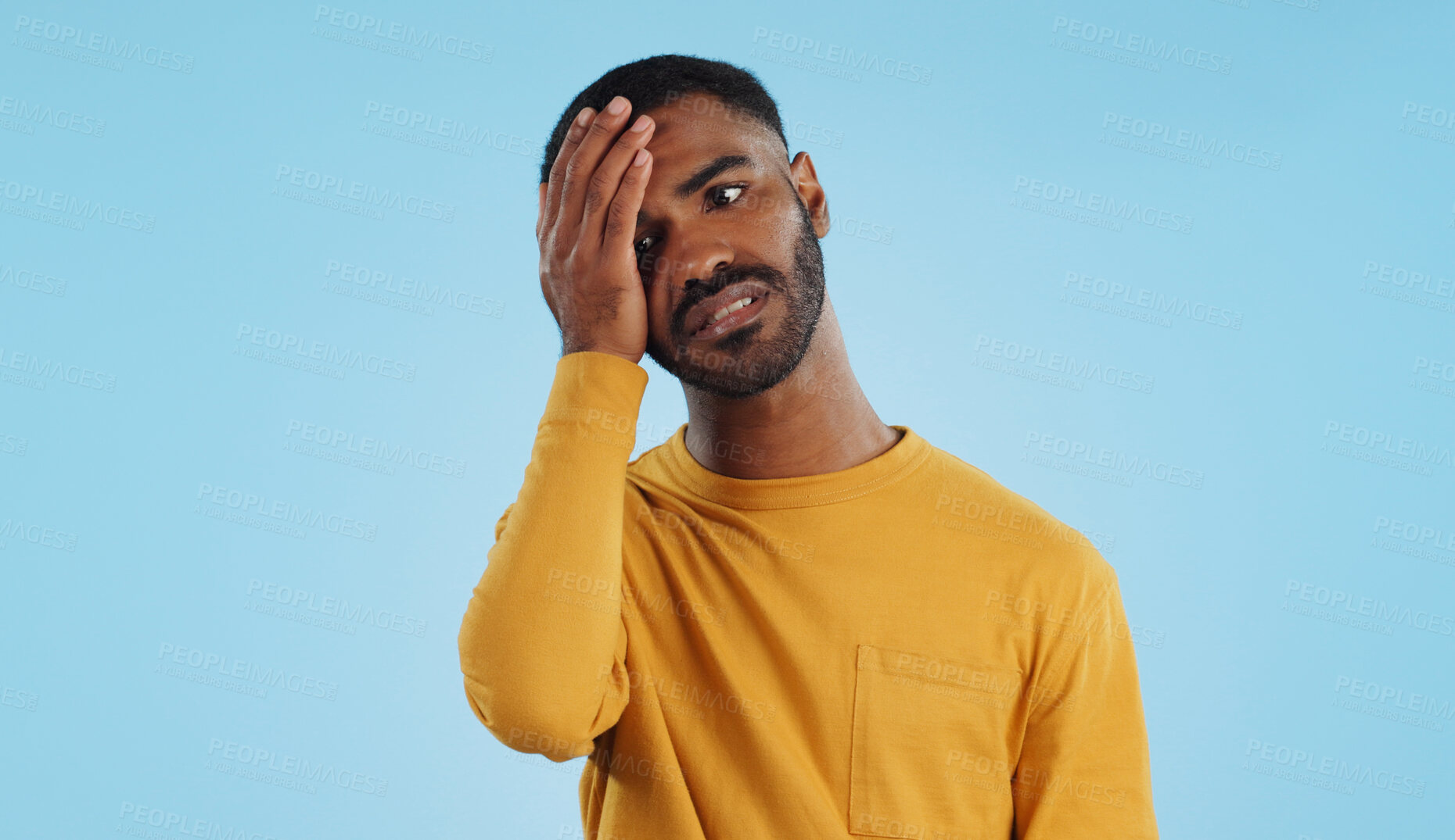 Buy stock photo Stress, fail and man in studio with facepalm emoji for stupid mistake or regret on blue background. Anxiety, oops and male model with disaster, crisis or fake news shame, frustrated and unhappy