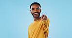 Face and man with hand pointing at you in studio with choice, selection or offer on blue background. Opportunity, offer and portrait of male model with emoji for join us, deal or invitation