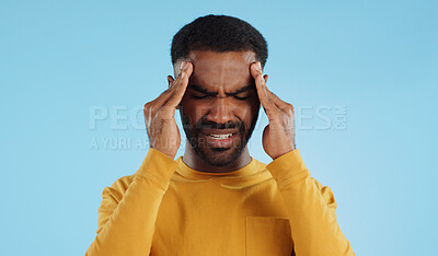 Stress, tired and a man with headache pain on a blue background from burnout or anxiety. Mental health, fatigue and a person with a migraine massage, frustrated and with depression and anger