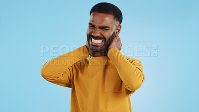 Buy stock photo Neck pain, stress and man in studio frustrated with arthritis, tension or pressure on blue background. Shoulder, anxiety and face upset male model with burnout, osteoporosis or fibromyalgia injury