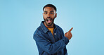 Advertising studio smile, man and pointing at ads commercial, retail information or discount announcement. Sales info, mockup space and portrait person show service, deal or news on blue background