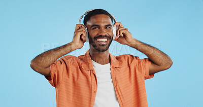 Man, student and headphones for listening to music, dance and mental health for education and wellness in studio. Young african person for audio streaming service, techno or rave on a blue background