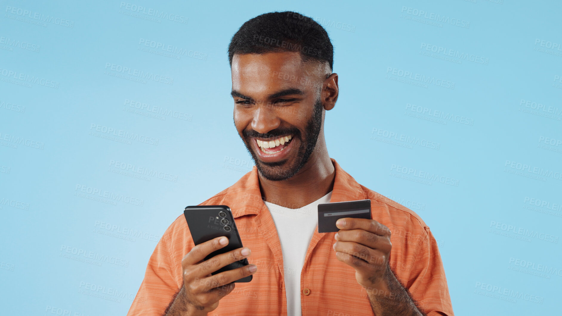 Buy stock photo Man, credit card and excited with phone, studio and thinking of sale, promo code or info by blue background. Online shopping, easy payment and happy for financial freedom, fintech app or smartphone