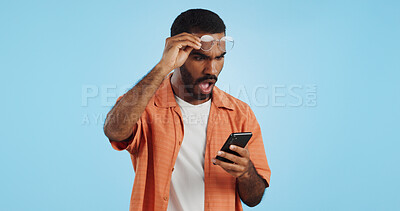 Buy stock photo Man, smartphone and surprise announcement with shock, facial expression and drama online on blue background. Wow, reaction to news on social media and communication, mobile app and alarm in studio