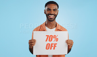 Buy stock photo Discount, sign and promotion, man and portrait, show information and smile isolated on blue background. Poster, billboard or banner with sale news, announcement on board with advertising in studio