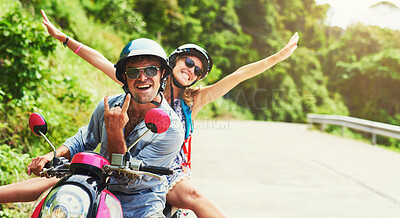 Buy stock photo Shot of a happy young couple exploring an exotic destination by scooter